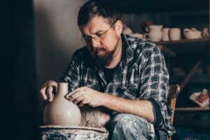 master works on the potter s wheel creating a jug of clay.jpg