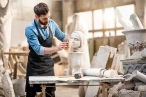 sculptor working with sculpture in the studio.jpg
